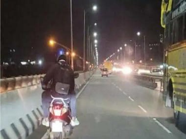Viral: Man works on laptop while riding pillion, image divides internet