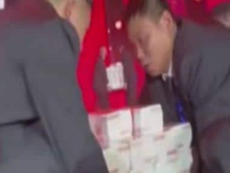 Chinese company piles $9 million to give staff bonuses, video of cash 'mountain' goes viral