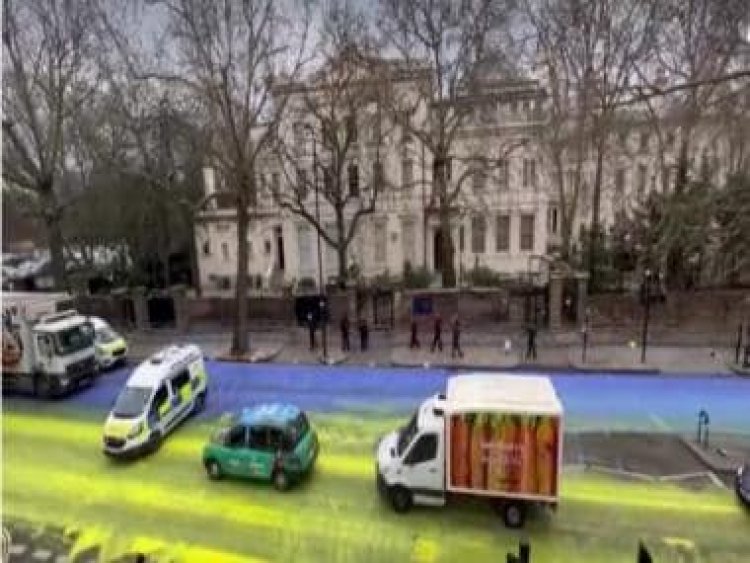 Demonstrators paint huge Ukrainian flag outside Russian embassy in London