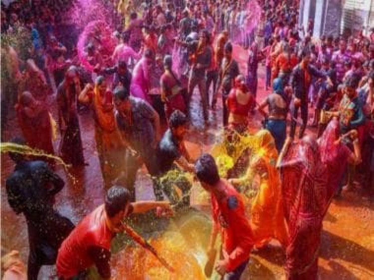 Why is Holi called festival of colours and what do red, pink, blue and green symbolise?