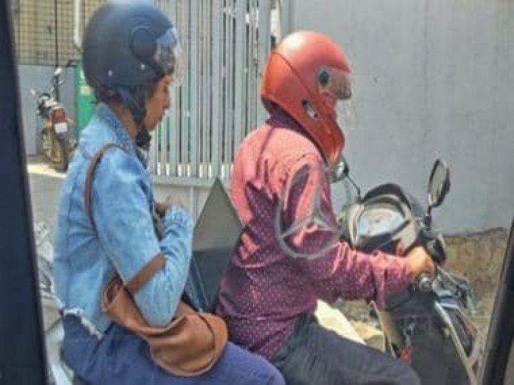 Stuck in Bengaluru traffic, woman balances laptop and starts working on Rapido bike